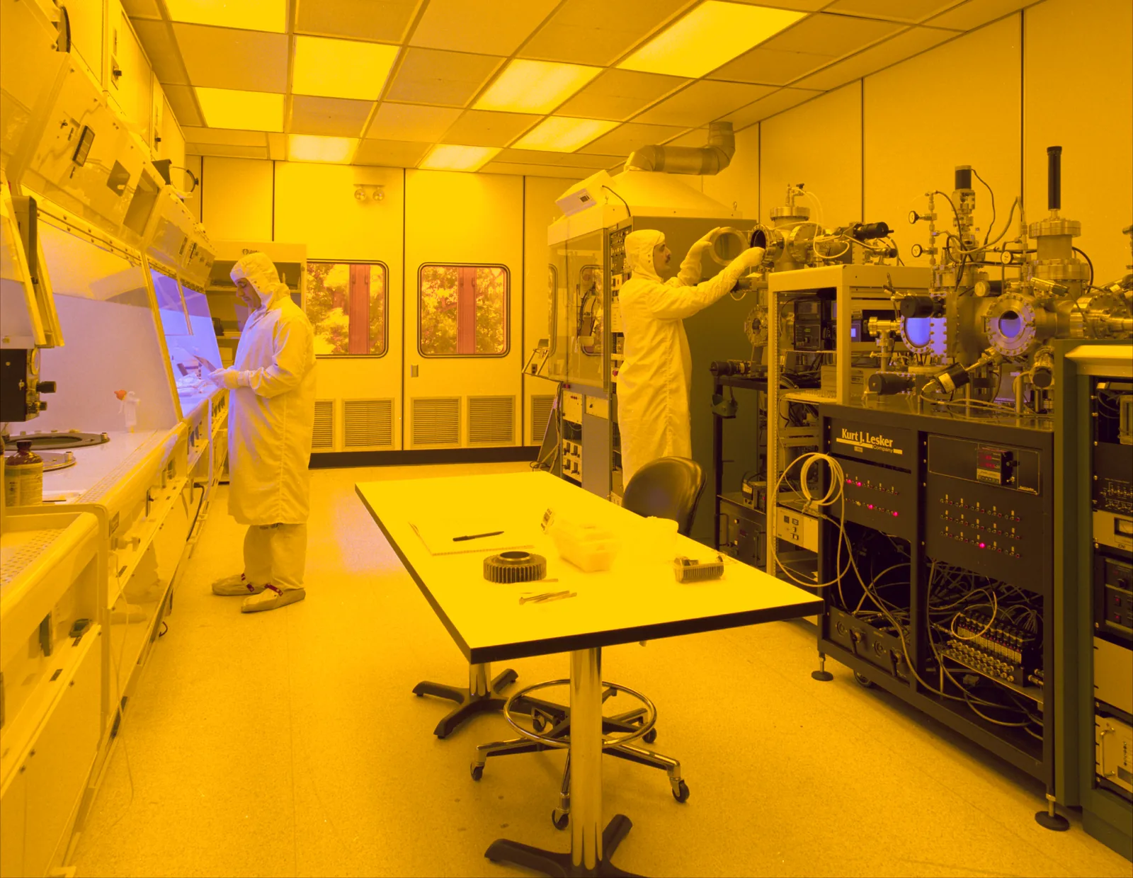 Technicians working in a controlled cleanroom environment